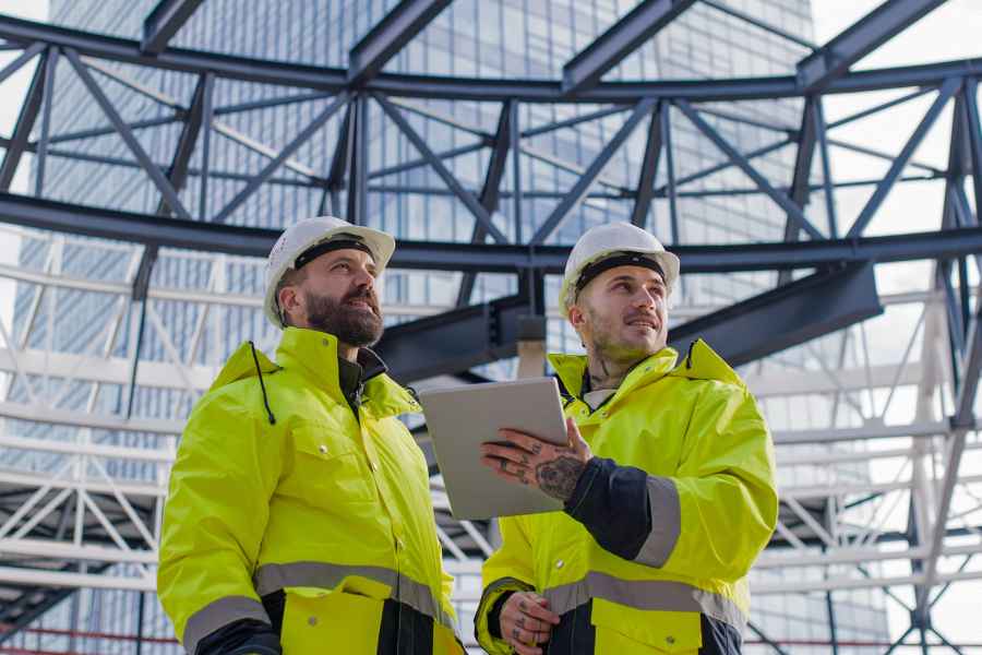 two construction workers wearing safety jackets